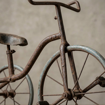 Close-up of the RM-70142 iron cycle highlighting intricate metal textures, rivets, and weathered paint with a textured background.